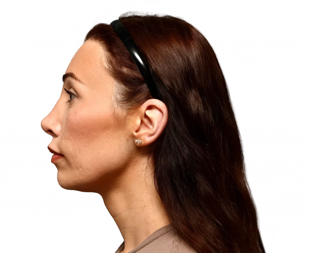 Side profile of a woman wearing a black headband, brown hair, and small earrings.