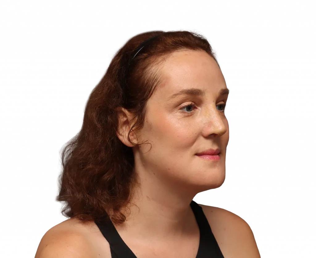 Profile portrait of a woman with brown wavy hair in a black tank top, facing right against a black background