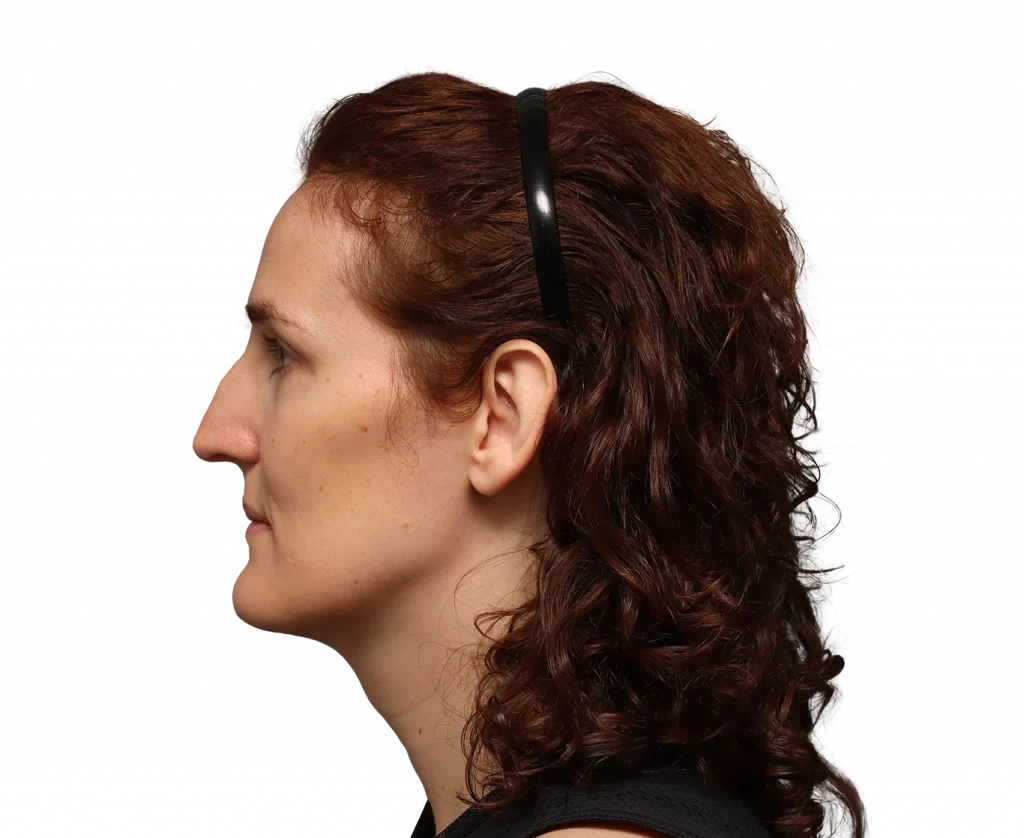 Profile view of a woman with brown curly hair wearing a black headband, facing left.