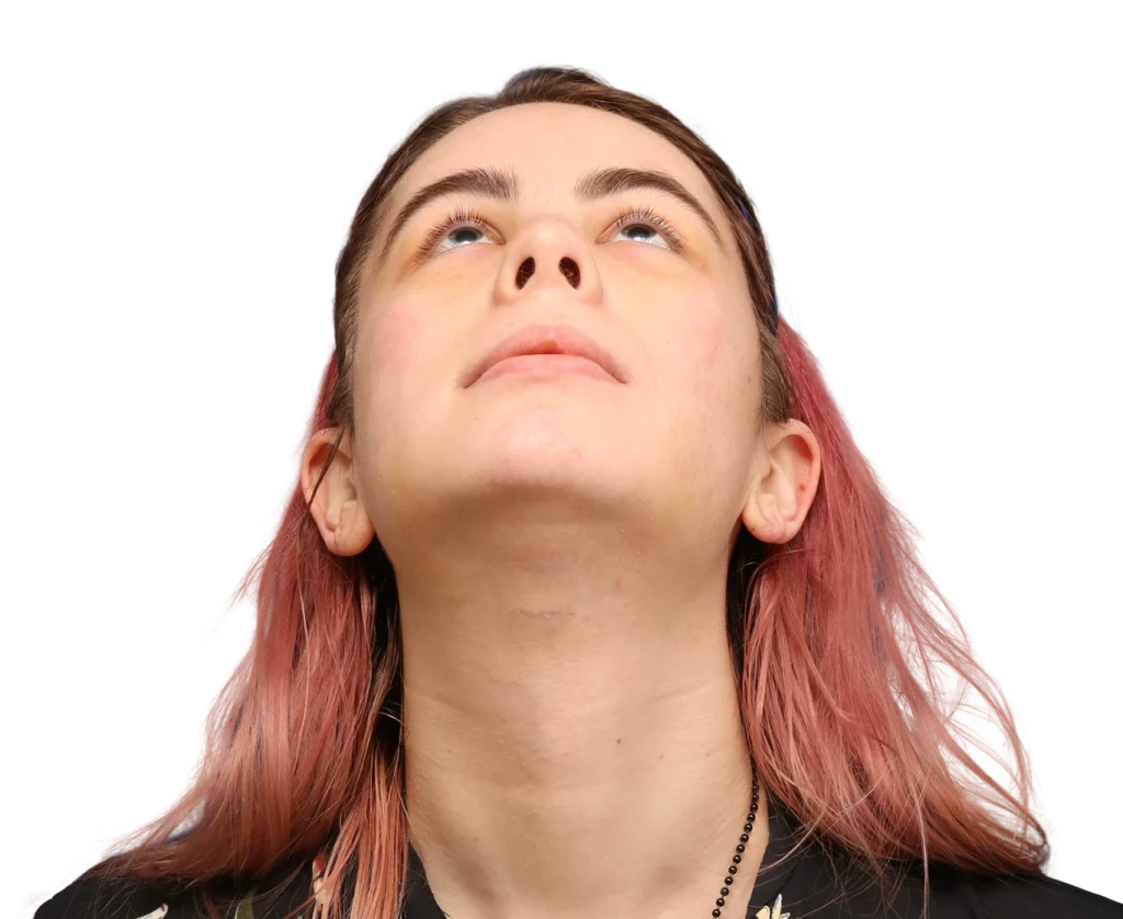 Person tilting their head back and looking upward, showing their face and neck against a plain background