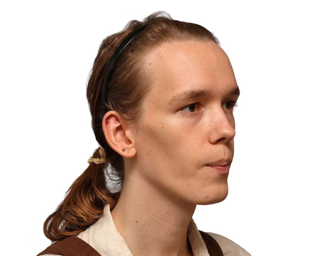 Profile of a young woman with light brown hair in a ponytail, wearing a black headband, looking to the right; small ear stud visible on her ear.